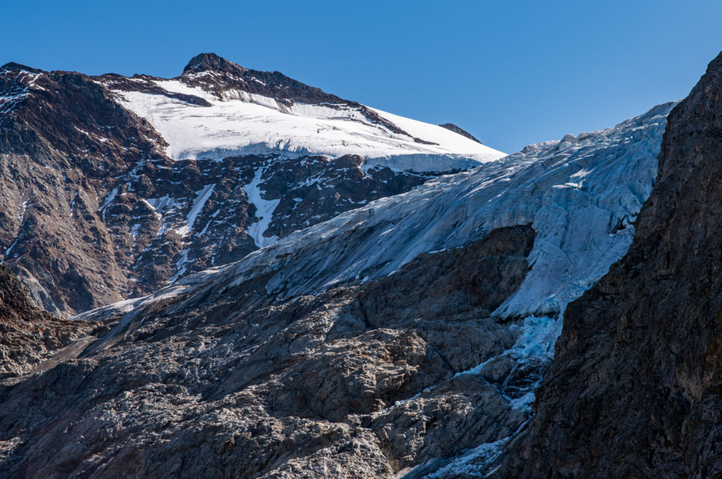 Gletscherabbruch mit Berggipfeln im nachmittäglichen Licht